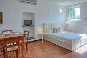 a bedroom with a bed and a table and a desk at Villa dell'Erta - Levanto in Montale