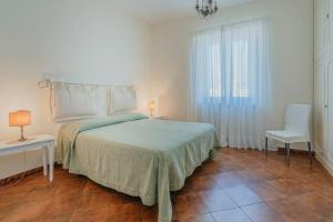 a bedroom with a bed and a table and a chair at Casa Gege', for up to 5 guests, shared pool, Sorrento center in Sorrento