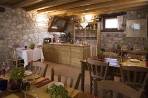 ヴィットリオ・ヴェネトにあるAgriturismo Altheaのテーブルと椅子のあるレストラン、キッチンが備わります。