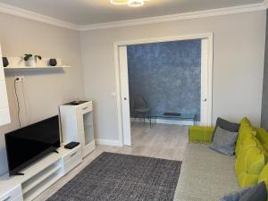 a living room with a couch and a television at Gabi Apartament in Suceava