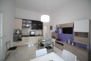 a kitchen with a table and some chairs in it at B&b L'Incantesimo in Morciano di Leuca