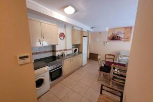 a kitchen with a table and a dining room at Apartamento vacacional Adriana , Montanejos in Montanejos