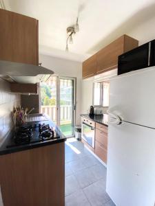 a kitchen with a white refrigerator and a stove at Superb Apartment In Cannes With Magnificent View ! in Cannes