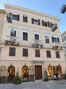 a large white building with a large window at Palazzo Bolasco in Alghero