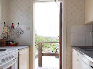 a kitchen with a door leading to a balcony at 6 person holiday home in Bovallstrand in Bovallstrand