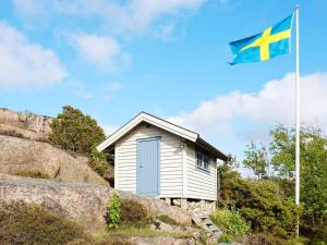 a flag flying in front of a small house at 6 person holiday home in Bovallstrand in Bovallstrand