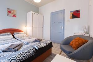 A bed or beds in a room at Holiday House Siófok