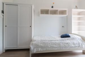 A bed or beds in a room at Holiday House Siófok