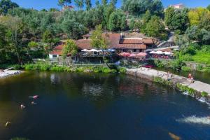 an aerial view of a river with people swimming in it at Casa do Curral do Chapéu in Coja