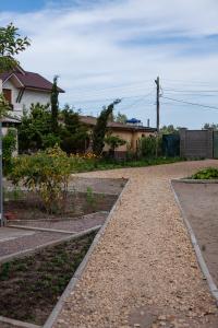 a gravel path in a yard with a house at Estate House in Zatoka +7 photos