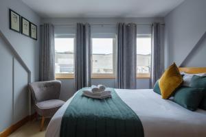 une chambre avec un lit avec une chaise et une fenêtre dans l'établissement The Eyre Square Townhouse, à Galway