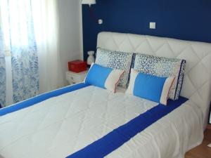 a large white bed with pillows on top of it at Villa Vanya in Skala Rachoniou +51 photos