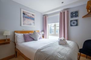 a bedroom with a bed with a towel on it at The Eyre Square Townhouse in Galway