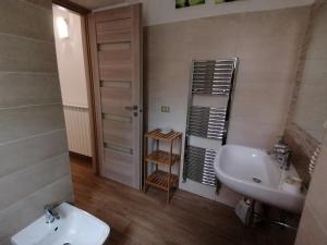 a bathroom with a sink and a toilet and a mirror at the Mainstreet in Agerola