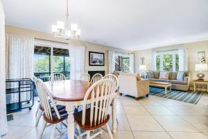 a dining room with a table and chairs and a couch at Carolina Boulevard 128 in Isle of Palms