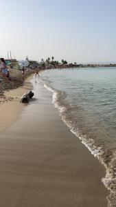 a beach with people on it and the water at Il Telescopio in Noto