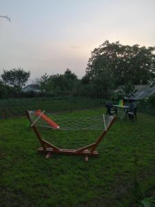a hammock in a field with a picnic table at Villa Apartments STEFAN - Ramne Ohrid in Ohrid