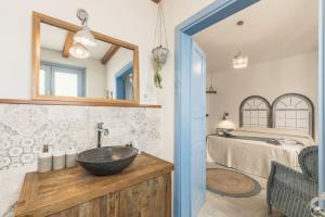 a bathroom with a sink and a bed at B&B Antico Telaio in Santa Maria Navarrese