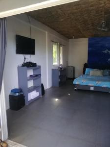 a bedroom with a bed and a flat screen tv at Anajawan Island Beachfront Resort in General Luna