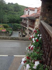 un balcón con flores en el lateral de una casa en Posada Rural Peñasagra en Quintanilla