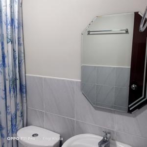 a bathroom with a sink and a mirror at Hachiko Pretty Homes Condominium at Saekyung956 Condominium, Looc, Lapu-lapu City, Cebu, Philippines in Mactan