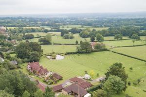 an aerial view of a house in a field at Motor House Loft by Bloom Stays in Sandhurst