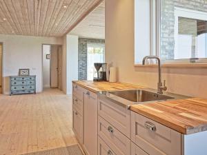 a kitchen with a sink and a counter top at 6 person holiday home in Svaneke in Svaneke