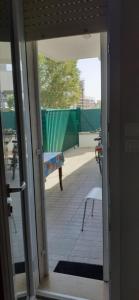 an open door to a patio with a bench at La playa nei pressi del mare in Montesilvano