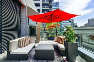 a red umbrella sitting on top of a balcony at Hotel Trusty Osaka Abeno in Osaka