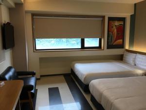 Voodi või voodid majutusasutuse Fu Kuang Hotel toas