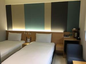 Voodi või voodid majutusasutuse Fu Kuang Hotel toas