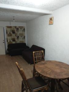 a living room with a table and a couch at Casa con alberca Ixtapa Zihuatanejo in Ixtapa