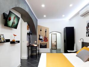 a bedroom with a bed and a tv on the wall at ALCENTRO Orange Home in Venafro