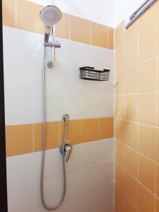 a shower with a shower head in a bathroom at ALCENTRO Orange Home in Venafro