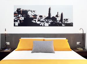 a bedroom with a bed with a black and white at ALCENTRO Orange Home in Venafro