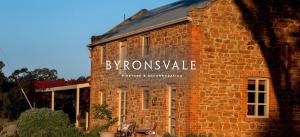 a brick building with a sign on the side of it at Byronsvale Vineyard and Accommodation in Bendigo
