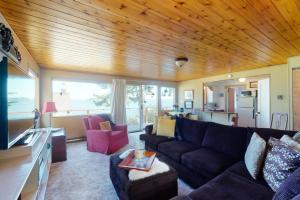 a living room with a couch and a table at Private Beach - Book Port Ludlow Beach Cottage and Camper Together in Port Ludlow