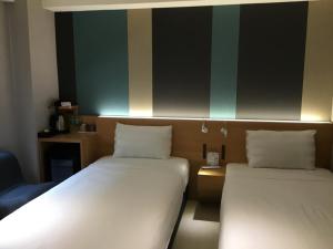 Voodi või voodid majutusasutuse Fu Kuang Hotel toas