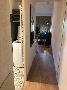 a hallway with a door open to a living room at studio Bel Air in Saint-Georges-dʼOrques