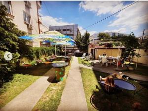 a patio with a table and an umbrella at Nordic Hostel N-Box in Skopje