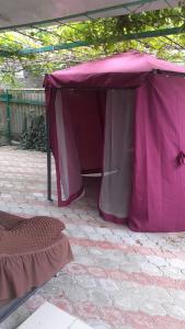 ゲレンジークにあるДом с дворомのレンガ造りのパティオに座る紫色のテント