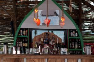 a bar with a man behind a counter with alcohol at Blue Orange Beach Resort in Sozopol