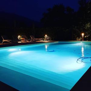 a large swimming pool at night with blue illumination at Hotel Diana in Boario Terme
