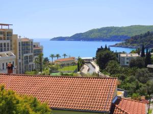 a view of the ocean from the roofs of buildings at Rooms Villa Desa in Budva
