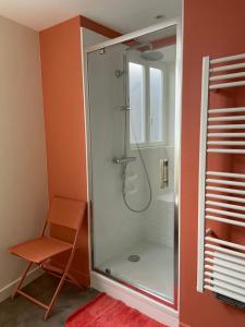 a shower with a glass door in a bathroom at AU COEUR DES SOURCES - Face aux Parcs & Thermes - Hypercentre in Vichy
