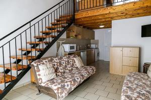 a living room with a couch and a staircase at Seaview Apartments Tsilivi in Tsilivi