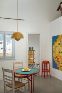 a dining room with a table and chairs at Le Grand Blue Villa in Akrotiri +59 photos