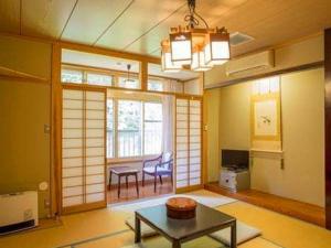 uma sala de estar com uma mesa e uma sala de jantar em Oyado Fubuki em Nozawa Onsen