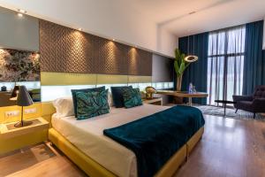 a bedroom with a large bed and a living room at La Finca Resort in Algorfa
