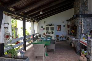 a dining room with a green table and chairs at Country House Vrbovčanka in Daruvar